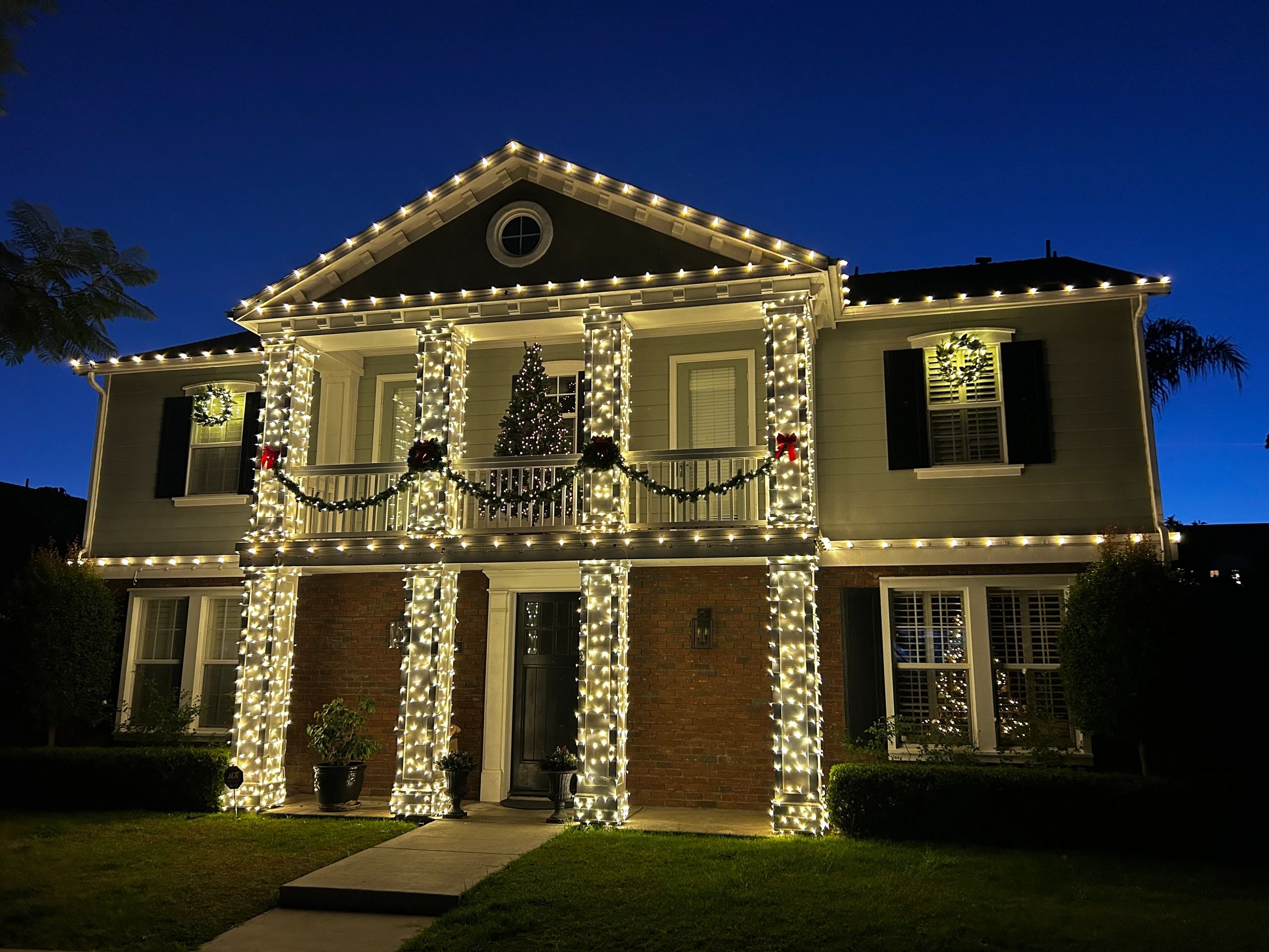Home with holiday string lights at twilight